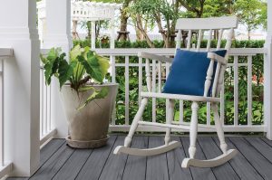 white wooden rocking chair on front porch at home